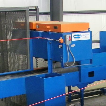 Overhead magnetic separator suspended over a sort conveyor in a recycling plant