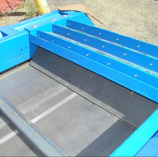 Conveyor loading section with rubber belt and bolted steel skirt plates, fabricated in the shop