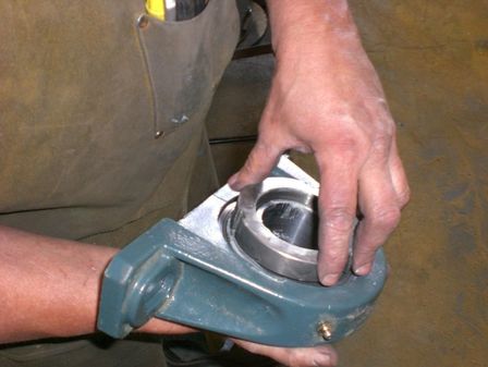 Replacement bearing for a conveyor pulley shaft
