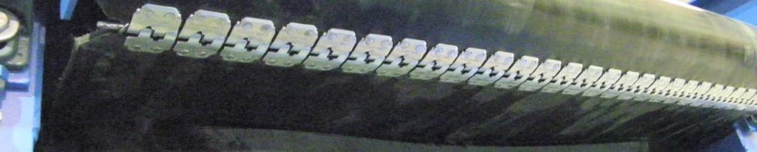 Close-up of belt lacing on a slider bed rubber belt conveyor