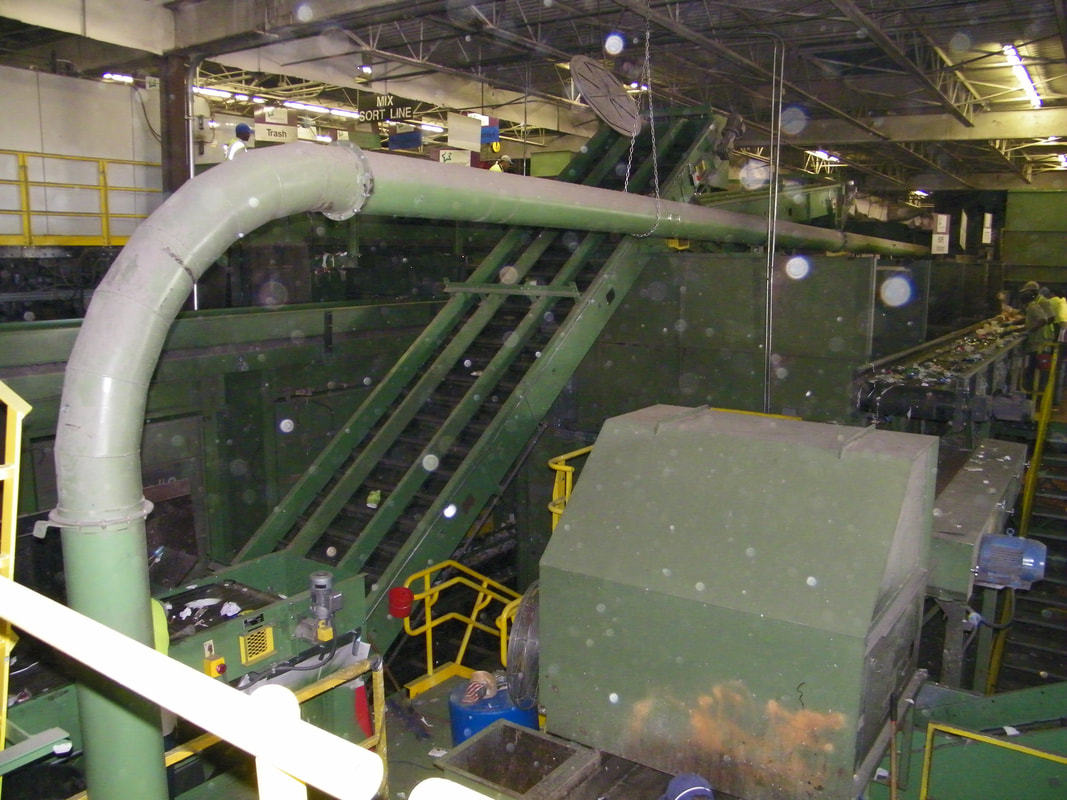 Blower tube routed overhead for conveying material through a recycling plant