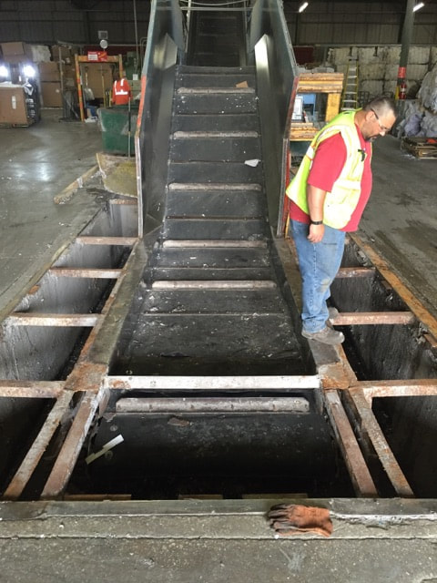 In-ground conveyor with belt, sprockets, and pit support steel removed