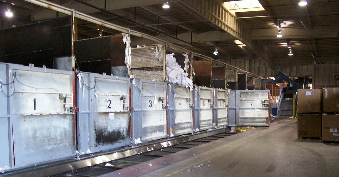 Old in-ground horizontal conveyor section with the new incline section visible at the far end