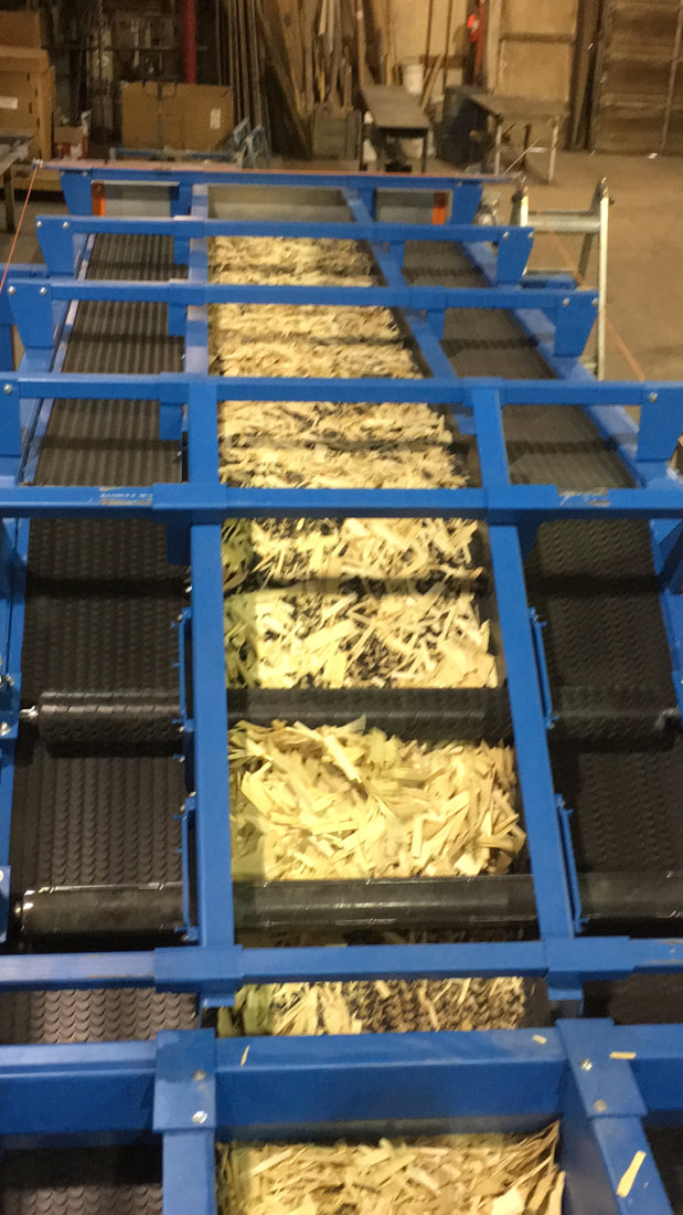 Tail end view of the articulated conveyor with side skirting set to the narrow material-width position