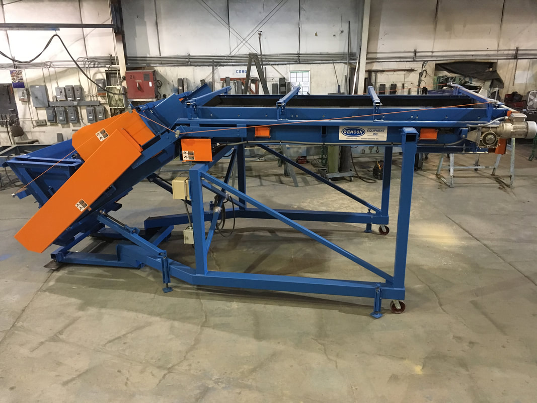 Remcon custom articulated adjustable-incline feed conveyor for wood chips and sawdust