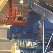 Crew installing a custom hood on a conveyor