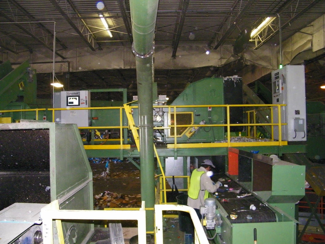 Optical sort conveyor installed on an elevated platform inside a running recycling plant