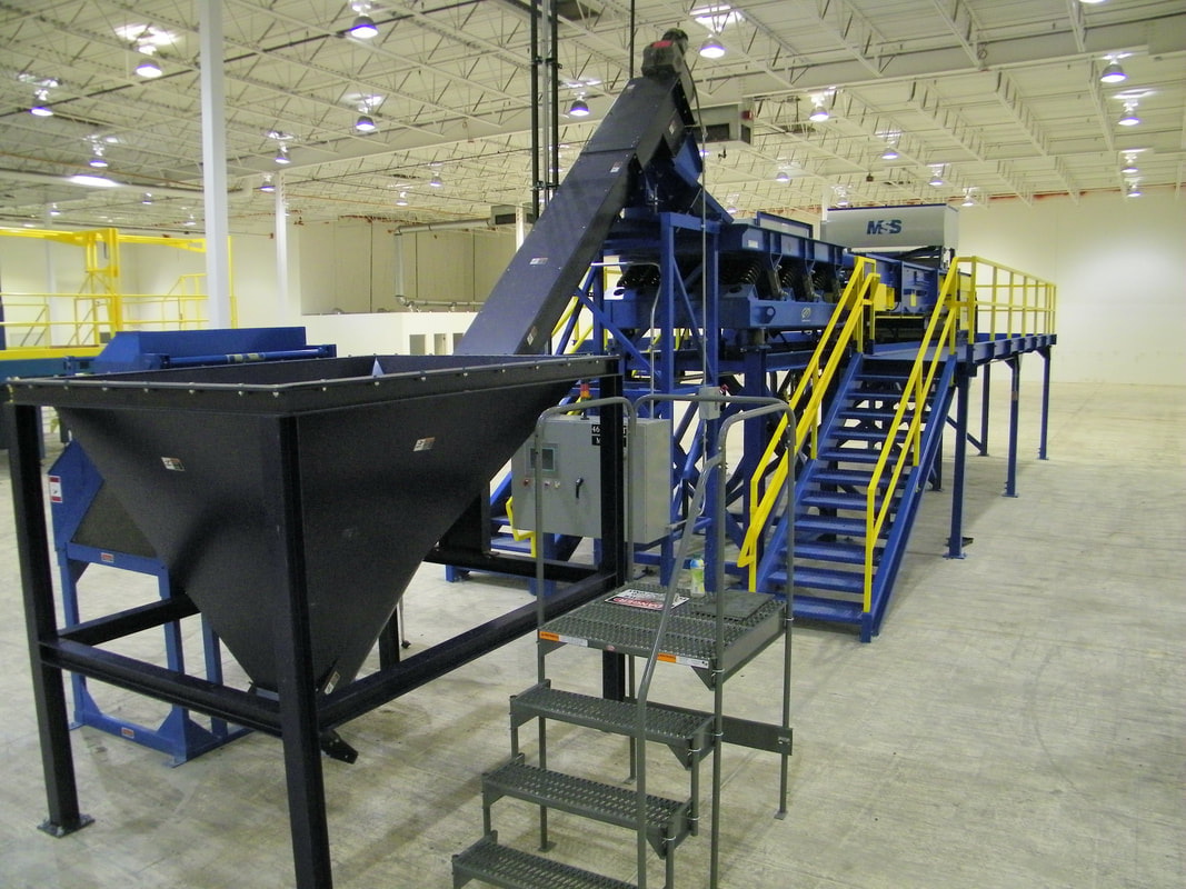 High-speed conveyor and containment hood feeding optical sorting equipment on the e-sort system
