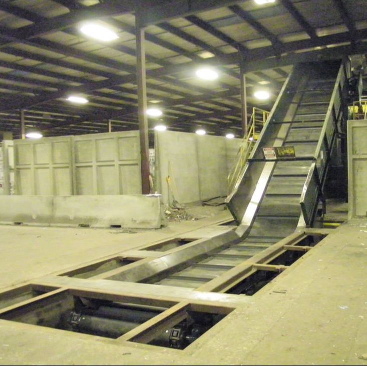 In-ground chain belt conveyor feeding an incline section for baler or sort line feeding