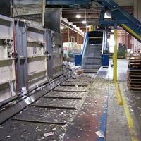 In-ground chain belt infeed conveyor with storage bunker doors