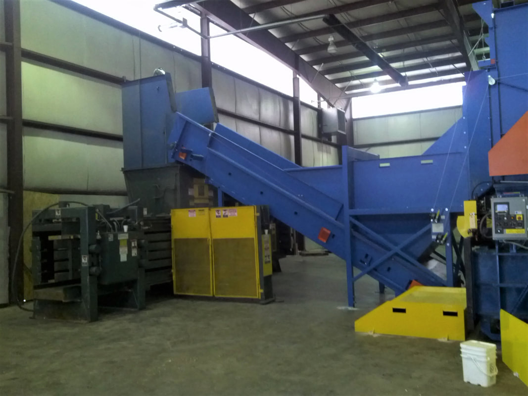 Two-way redirection chute directing material to the back-up baler feed conveyor