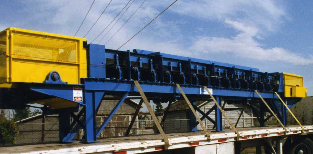 Side view of a heavy-duty troughing idler conveyor for a silver mine