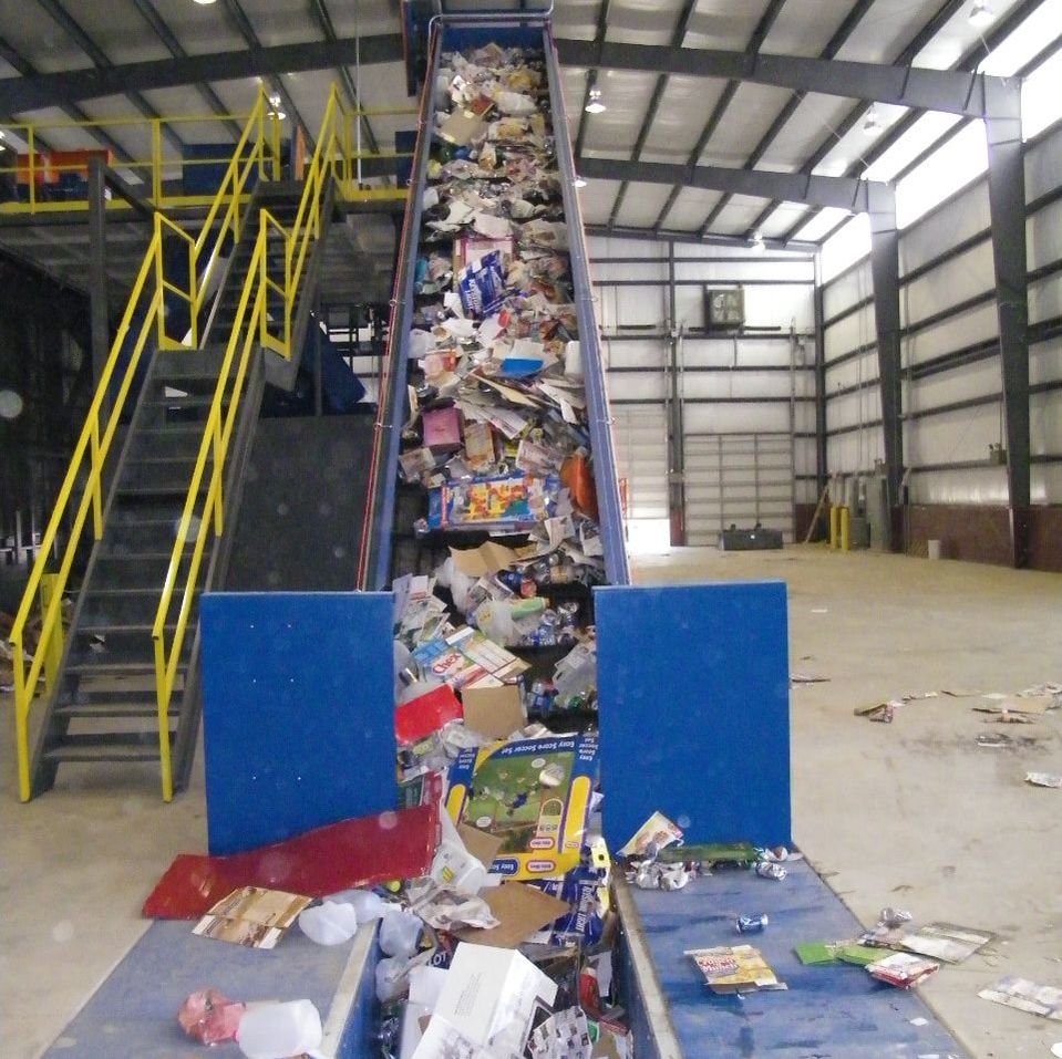 Incline slider bed sorting line feed conveyor carrying material, end view
