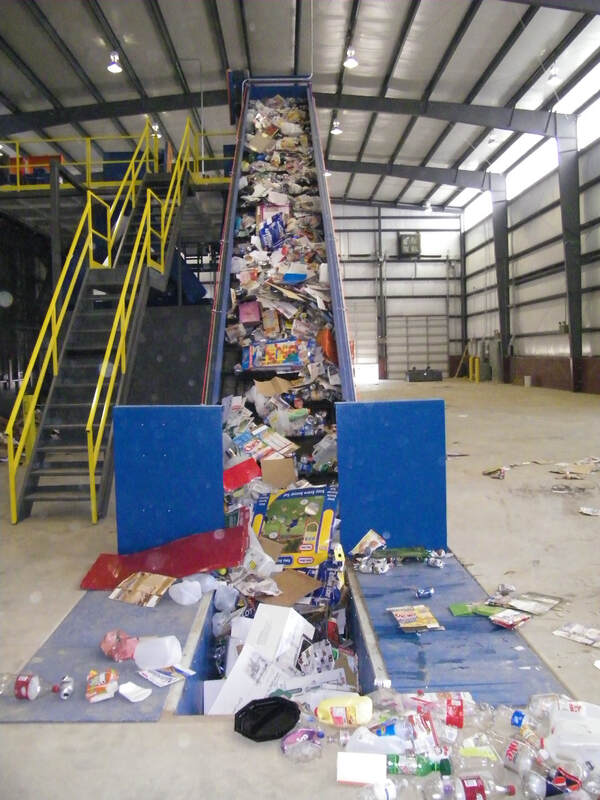 Remcon infeed conveyor with in-ground loading pit carrying recyclable material