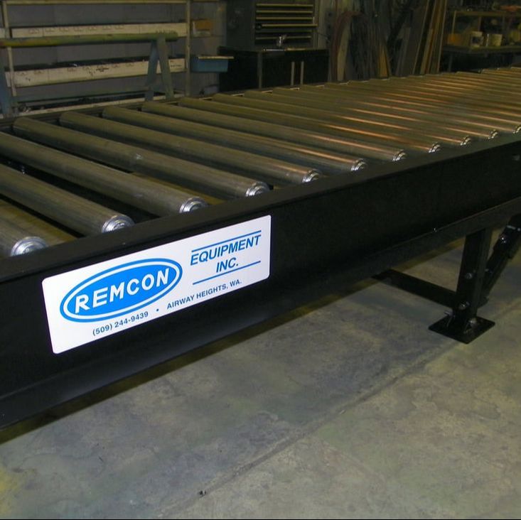 Heavy-duty roller conveyor built by Remcon, side view in the shop