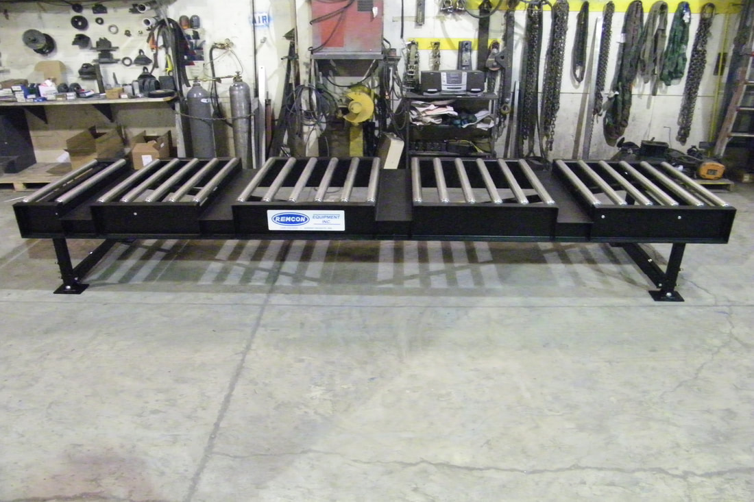 Custom heavy-duty roller conveyor with customer-specified fork pocket openings