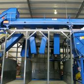 Sort conveyor elevated over storage bunkers with custom drop chutes