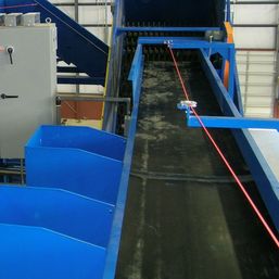 Remcon sorting conveyor with emergency stop cable and drop chutes