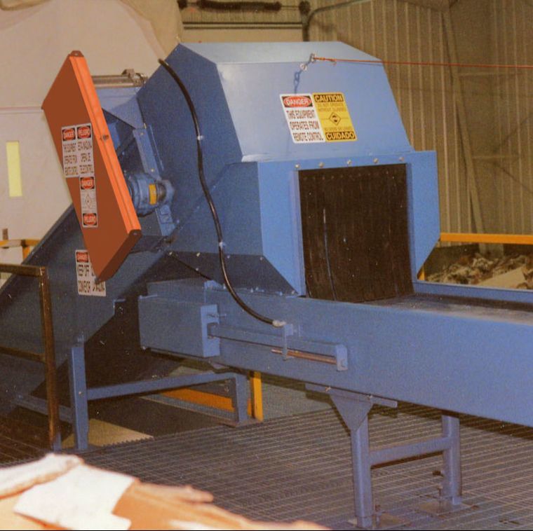 Sort conveyor fed by a feed conveyor with custom hood and transition chute