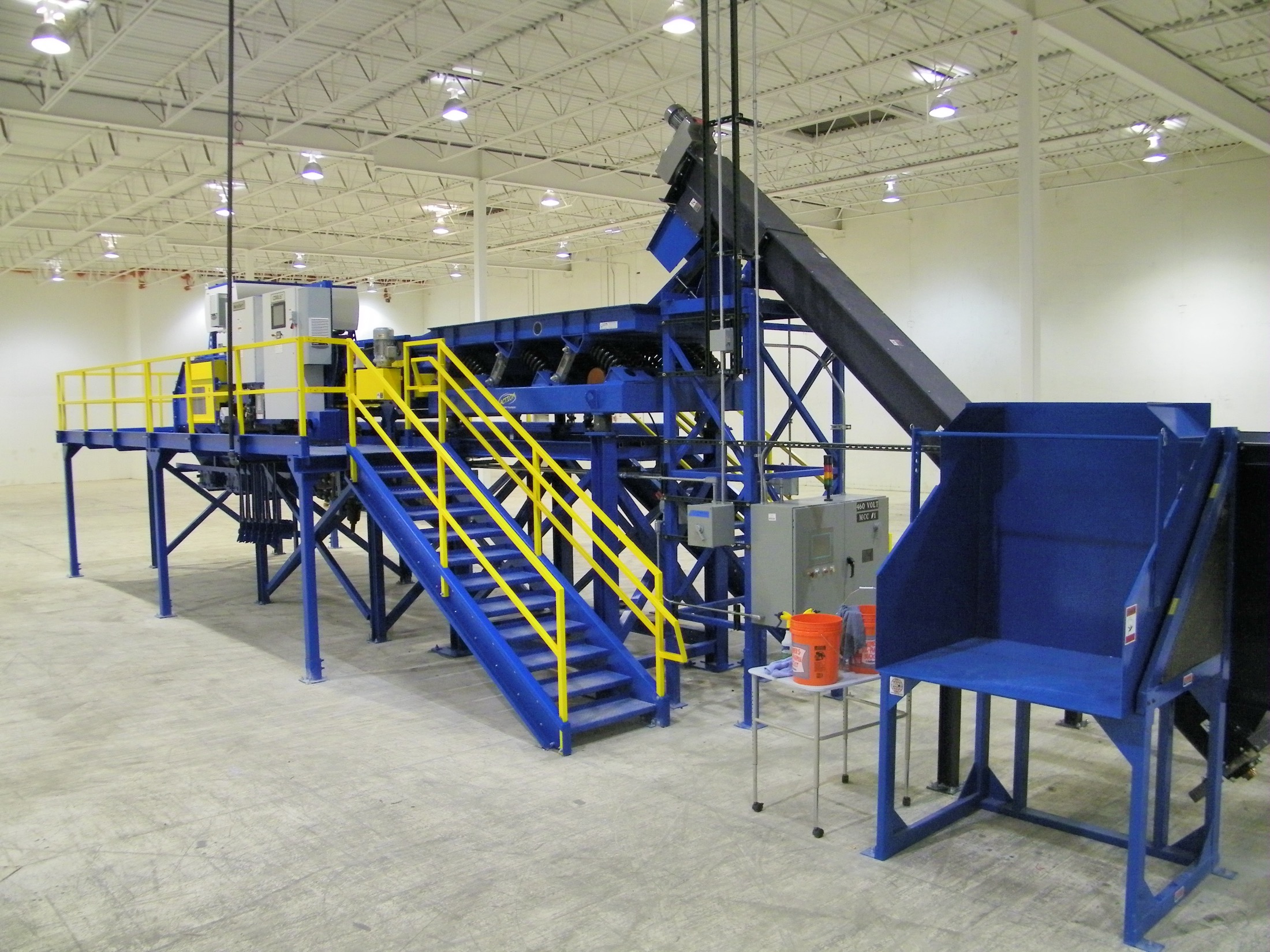 Turn-key sort system with disc screen, access stairs, and 460-volt motor control center