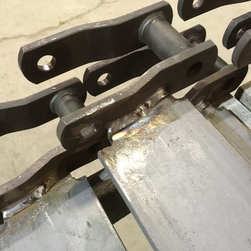Replacement drag chain conveyor back bars and chain links welded in the shop