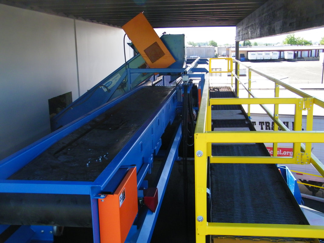 Reversing shuttle conveyor with tracks and festoon cable system