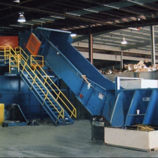 Low-profile above-ground loading section on a Remcon slider bed conveyor
