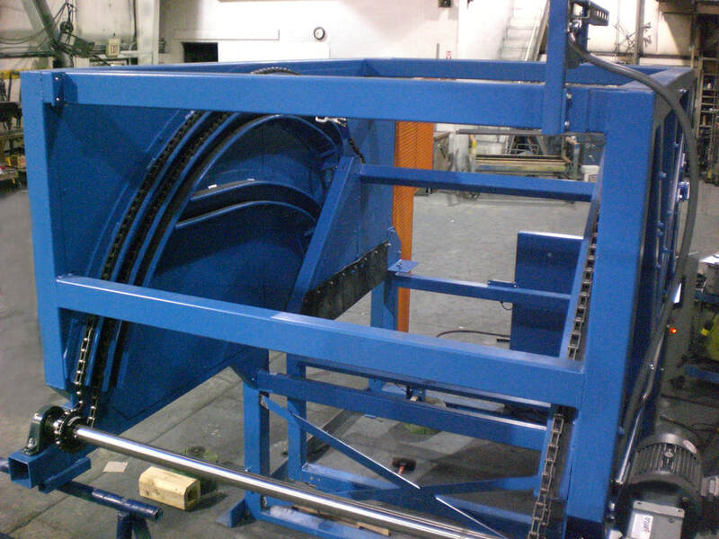 Chain-driven tote dumper showing frame, casters, and drive side